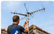 Aerial engineer repairing rooftop aerial
